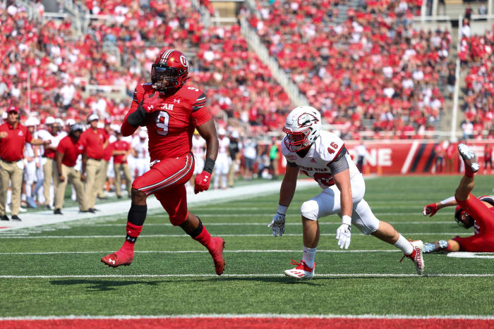 Utah Utes running back Tavion Thomas (9) runs for a touchdown against Southern Utah Thunderbirds linebacker Kohner Cullimore (46) in the first quarter at Rice-Eccles Stadium.